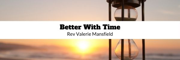 Hourglass in front of sunset,black text, Better With Time, Rev Valerie Mansfield